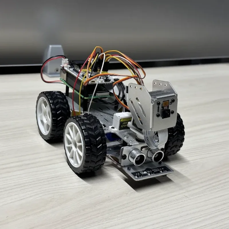 The rover nearly front on, from its right: the camera bracket and the range sensors face forward over a strip of line sensors.