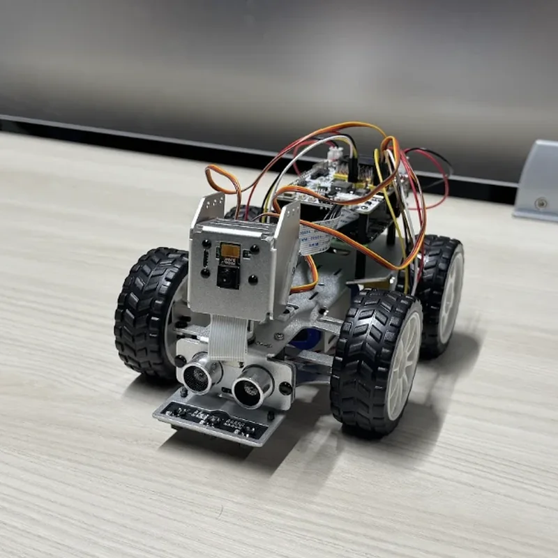 The rover from just left of its nose: the camera's ribbon cable hangs down behind the range sensors.